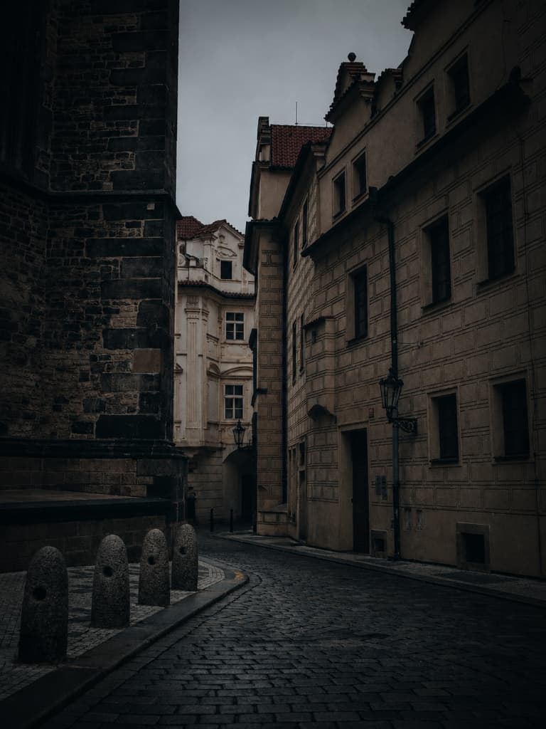 Atmospheric historic cobblestone street in Prague with lantern and stone architecture