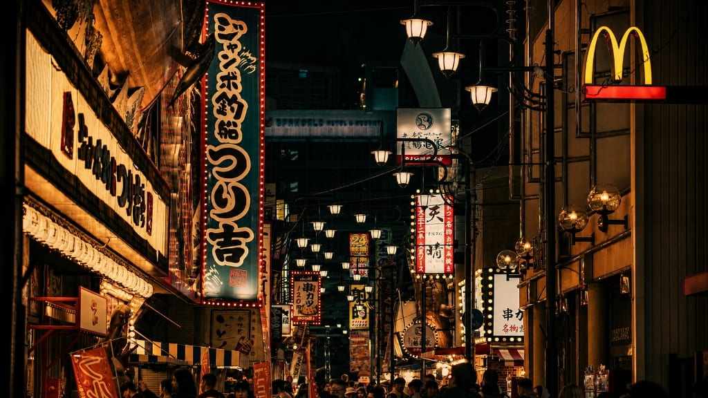 Vibrant Tokyo night street with illuminated vertical banners and neon signs
